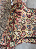 Primitive antique Caucasian rug with yellow background, repeating paisley motifs, handmade wool tribal carpet.