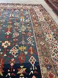 Close view of antique Caucasian tribal rug showing varied shades of blue including rare French blue tones.