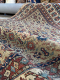 Antique wool tribal rug with scattered wear and beautiful old world character.