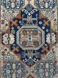 Antique tribal rug from the Caucasus with bold central medallion and crosses.