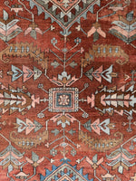 Heriz rug with central medallion and tribal design elements