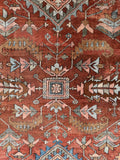 Heriz rug with central medallion and tribal design elements