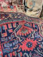 Navy field Persian Kurdish rug with graphic tribal art.