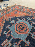 Close up of bold navy field and geometric motifs on Kurdish woven Malayer rug