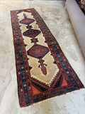 Antique 1920s Persian runner with three tribal medallions on ivory ground.