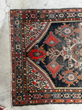 Kurdish tribal rug 4x7 with intricate paisley motifs and budding spandrels in saturated vegetable dyes.
