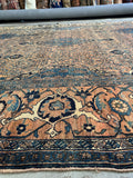 Antique Persian rug with heavy construction and soft wool underfoot.