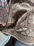 Vintage 1940s Shiraz with a soft neutral palette and tribal geometric design.