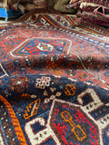 Close up view  of character and age in vintage Persian Shiraz rug.