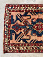 Protective S-hook motif along the rug’s main border.