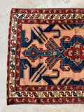 Protective S-hook motif along the rug’s main border.