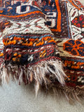 Close up detail of antique Shiraz rug with medium wool pile and a wool foundation.