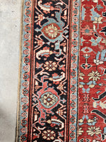 Close-up of unusual Heriz rug showing stylized flower forms and aged wool

