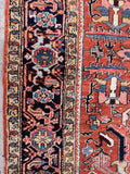 Terracotta navy blue tribal rug close-up shot highlighting the dark navy main border filled with stylized turtle motifs.