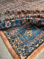 Intricately handwoven Persian Sarouk with a vibrant, romantic floral design