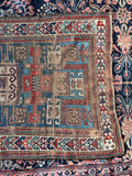 Symbolic Caucasian tribal wool runner featuring graphic geometric medallions on vibrant aqua ground.
