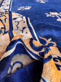 Oversized blue Peking antique rug showcasing the overall blue field and gold border.