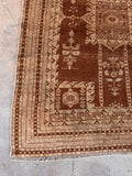 Vintage 1920s Indian rug hand woven with vegetable dyed wool in earth tone mocha and terracotta shades.