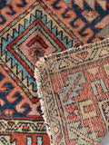 Underside of Persian Gharajeh Heriz rug, vegetable-dyed, low pile, navy and red field, worn but durable, perfect for high traffic spaces.