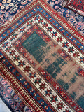 Circa 1900 Kazak rug woven with vegetable dyed green wool and multi-band border design.
