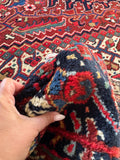 Vintage Heriz rug. Large Persian wool area rug with stemmed blossoms, serrated leaves, and a striking geometric medallion.