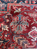 Antique Persian area rug. 1920s Heriz rug with bold tribal geometry, ivory corner spandrels, and a sturdy full-pile weave.