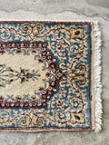 Vintage Kerman rug showing its thick wool pile and soft texture.