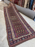 Full view of antique Persian rug with vegetable dyed wool and tribal designs.