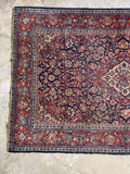 Finely woven antique Persian Tabriz area rug with ornate curvilinear floral design.
