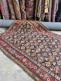 Early 1900s nomadic Caucasian rug handwoven with vegetable dyed wool.
