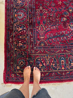 Corner view of Persian Lilihan rug that would be perfect for a statement space.