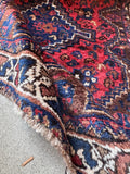 Baluch tribal scatter rug with a thick wool pile providing soft cushion underfoot.