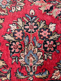 Traditional Persian antique carpet displaying vibrant colors, enduring strength, and classic floral motifs.