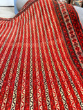 Vintage Persian red area rug featuring vertical geometric stripe pattern.