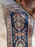 Vintage curvilinear floral runner displaying intricate motifs hand-knotted by village weavers.