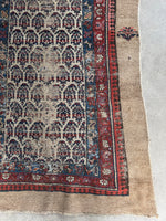 Corner view of Persian runner highlighting the boteh or paisley design in neat rows.