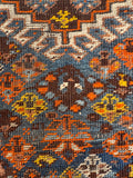 Antique Shiraz area rug showcasing multi-tone blue, chocolate brown, and orange wool.