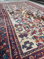 Persian rug with rust, aqua blue, and French blue accents.