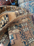 Underside view of handmade Turkmen wool runner rug detailed view highlighting authentic selvage edges and slight fringe wear.