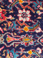 Close up view of Persian scatter rug with plush pile and classic design, crafted in the 1930s.