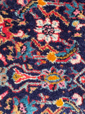 Close up view of Persian scatter rug with plush pile and classic design, crafted in the 1930s.