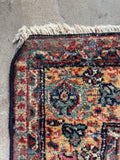 Antique Persian Mahal rug corner detail with aged patina.