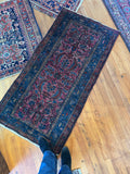 Antique Persian Malayer rug with punch pink field and inky navy border.