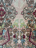 Vintage Persian Lavar wool rug floral field closeup with sage and celadon greens
