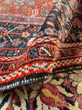 Border and corner detail of antique hand-knotted Persian Karaja tribal rug
