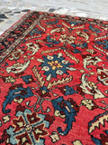 Vintage oriental Persian Malayer rug angled view, coral and navy
