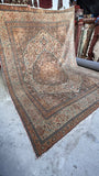 Natural light brings out honeyed brown, soft ivory and dusty pink in a large Persian Tabriz rug.