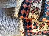 Vintage wool Kurdish bag face rug border fold showing soft pile
