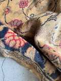 Close-up of vintage Turkish rug pile showing silky sheen of hand-knotted vegetable dyed wool and floral motif detail