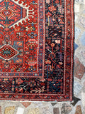 Border and corner detail of antique hand-knotted Persian Karaja tribal rug
